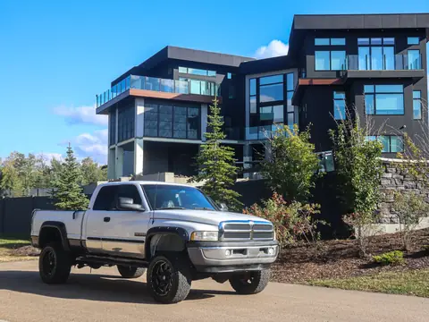 A pickup parked in front of a modern house, where the work is done